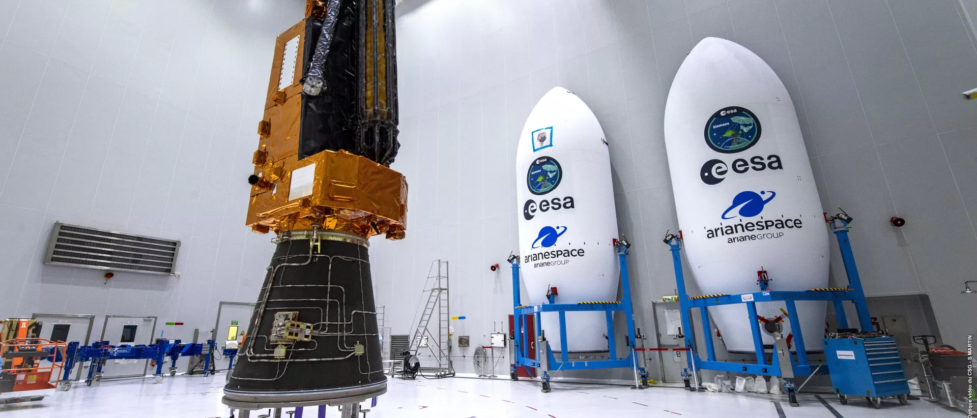 Biomass satellite on adapter with fairing shelves in the background